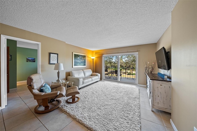 living room featuring a textured ceiling and light tile patterned floors