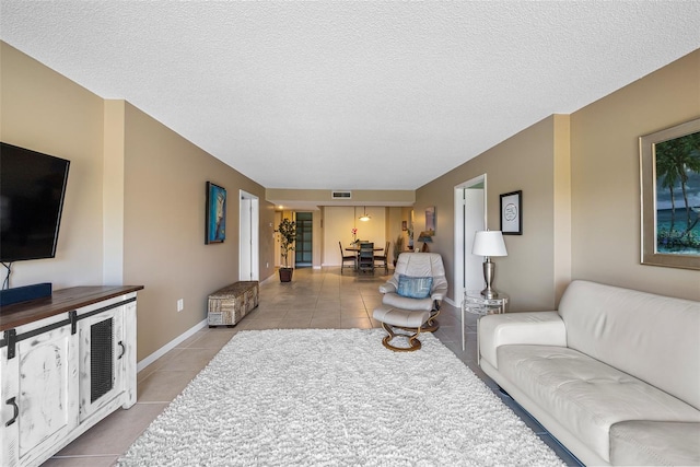 tiled living room with a textured ceiling