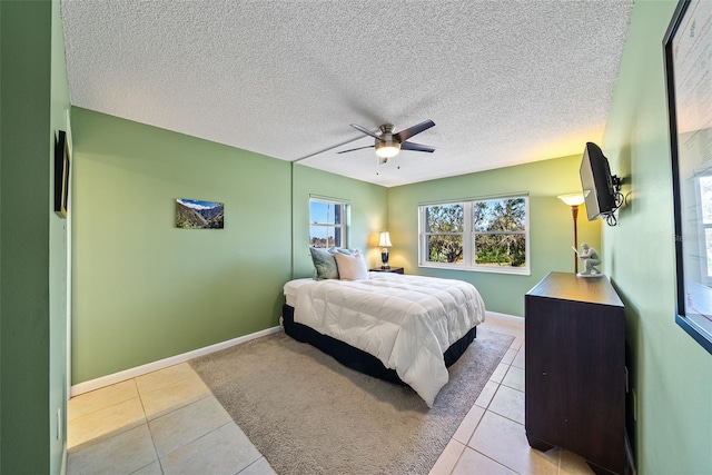 bedroom featuring light tile patterned flooring, a textured ceiling, and ceiling fan