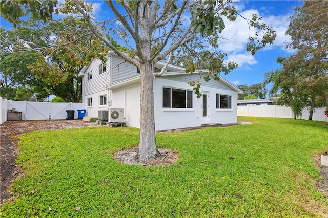 rear view of property featuring a yard