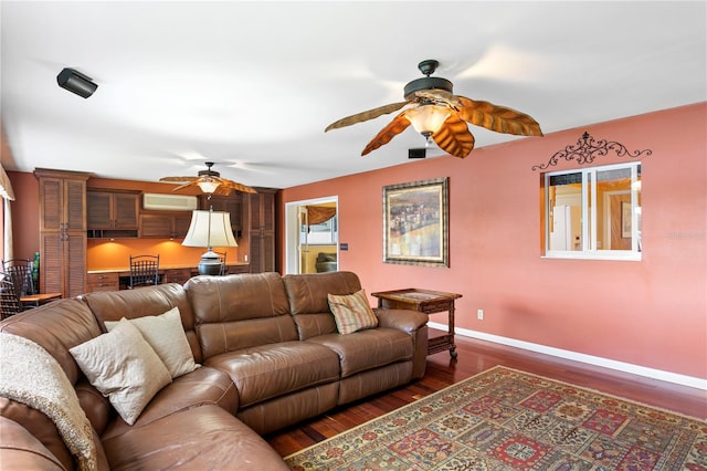 living room with a wall mounted AC, ceiling fan, and dark hardwood / wood-style flooring