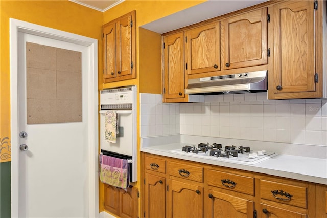 kitchen with backsplash and white appliances