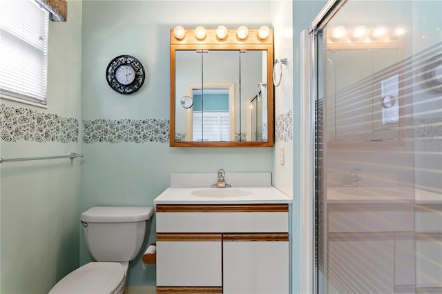 bathroom with toilet, walk in shower, and vanity