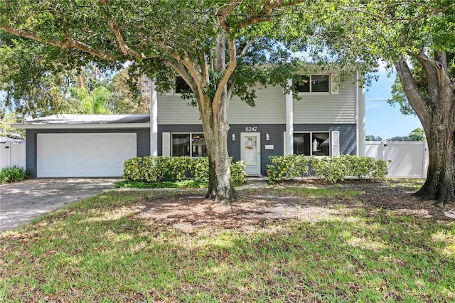 view of front of property with a front lawn and a garage