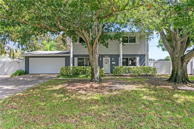 view of front of property with a front yard and a garage