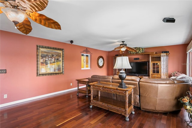 living room featuring ceiling fan and dark hardwood / wood-style flooring