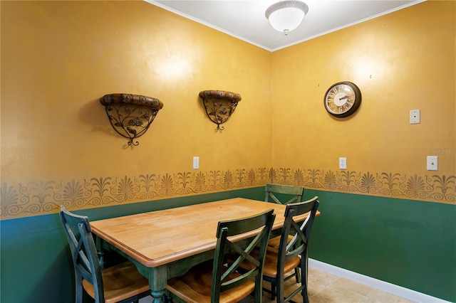 dining space with crown molding