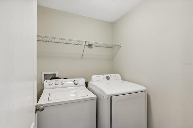 laundry area with washing machine and clothes dryer