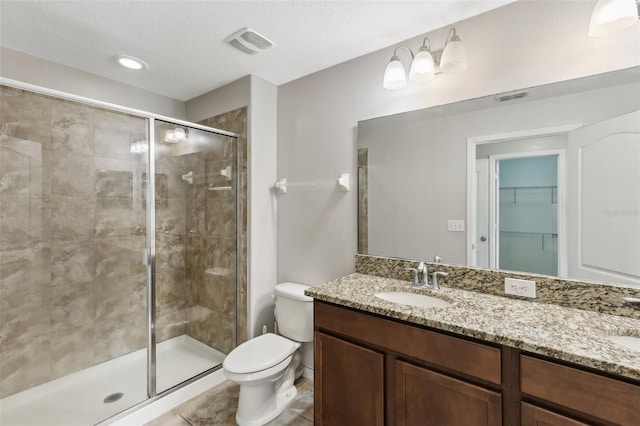 bathroom with vanity, toilet, and walk in shower