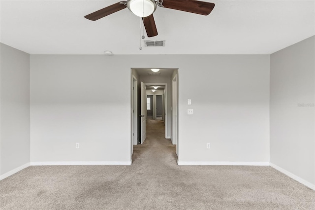 carpeted spare room featuring ceiling fan