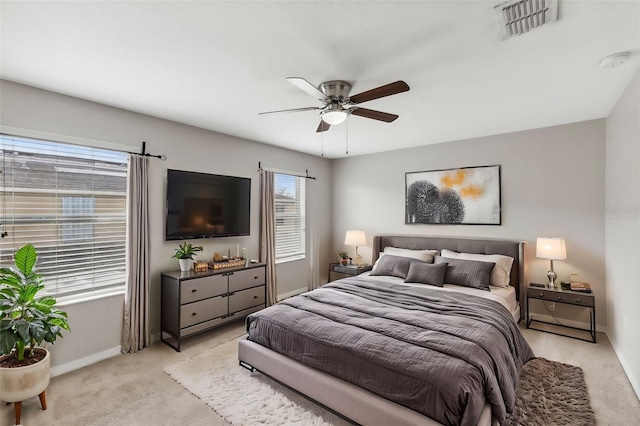 bedroom with ceiling fan and light carpet