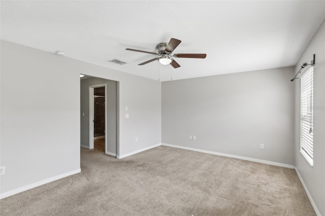 empty room with light carpet and ceiling fan