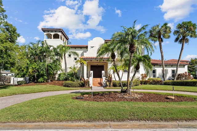 mediterranean / spanish house featuring a front yard