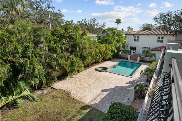 view of pool featuring a patio and a hot tub