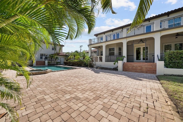 exterior space with a patio area, ceiling fan, and a jacuzzi