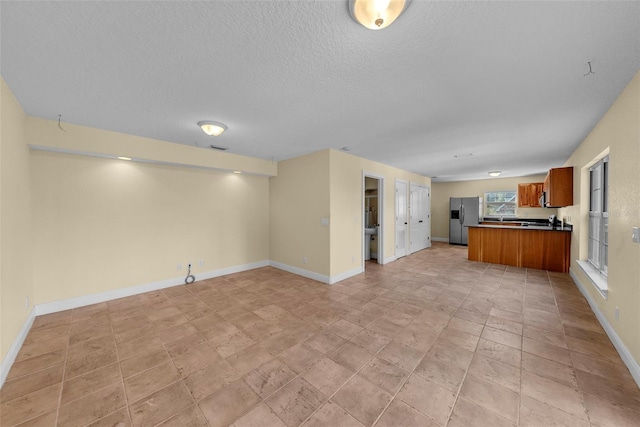 unfurnished living room featuring a textured ceiling