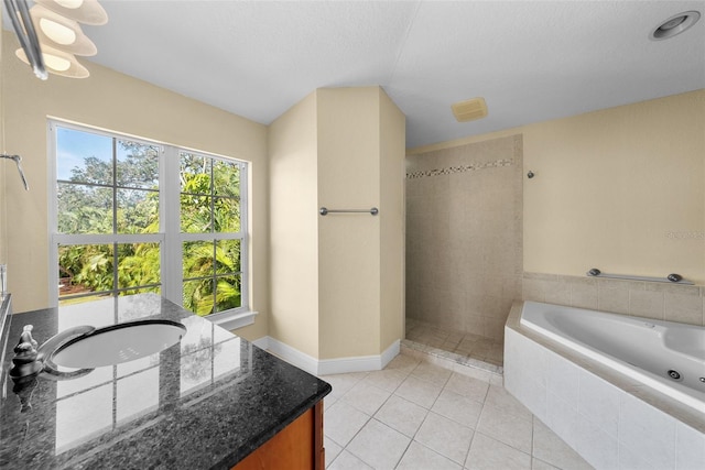 bathroom with tile patterned floors, independent shower and bath, and a textured ceiling