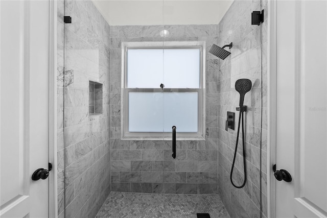 bathroom with a tile shower