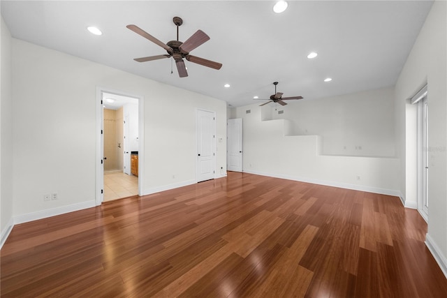 unfurnished living room featuring ceiling fan and light hardwood / wood-style flooring