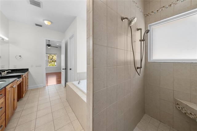 bathroom with tile patterned floors, plus walk in shower, vanity, and ceiling fan