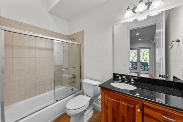 full bathroom featuring shower / bath combination with glass door, tile patterned floors, vanity, and toilet