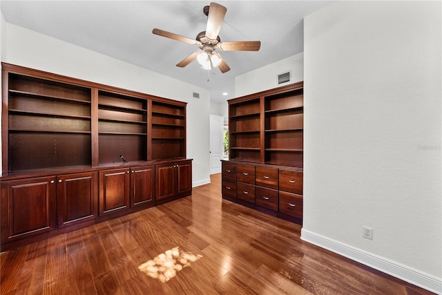 interior space with a textured ceiling, dark hardwood / wood-style flooring, and ceiling fan