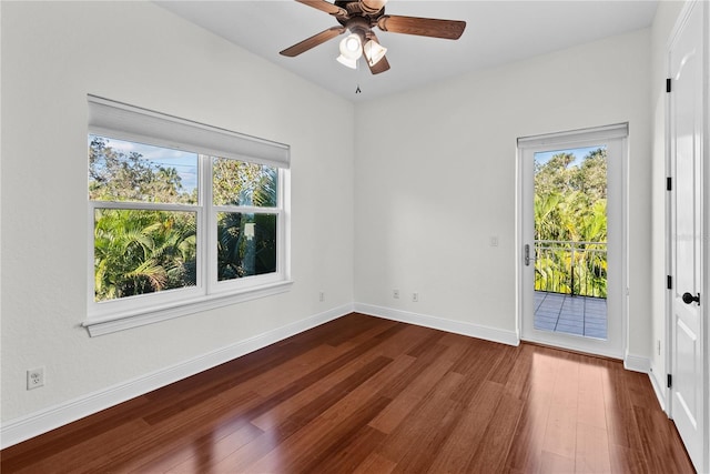 empty room featuring ceiling fan and dark wood-type flooring