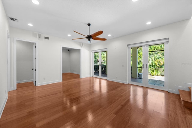 interior space with hardwood / wood-style floors, french doors, and ceiling fan