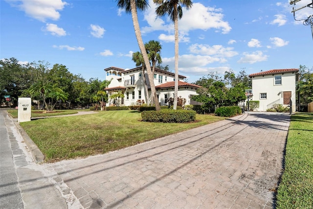 mediterranean / spanish-style home with a front lawn