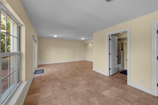 unfurnished room featuring a textured ceiling