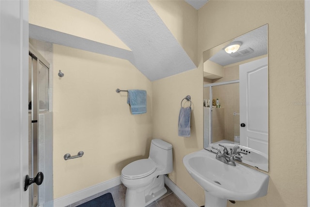 bathroom featuring tile patterned floors, sink, a textured ceiling, and toilet