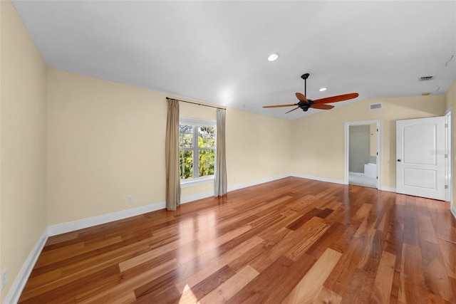 unfurnished room with ceiling fan, light wood-type flooring, and vaulted ceiling