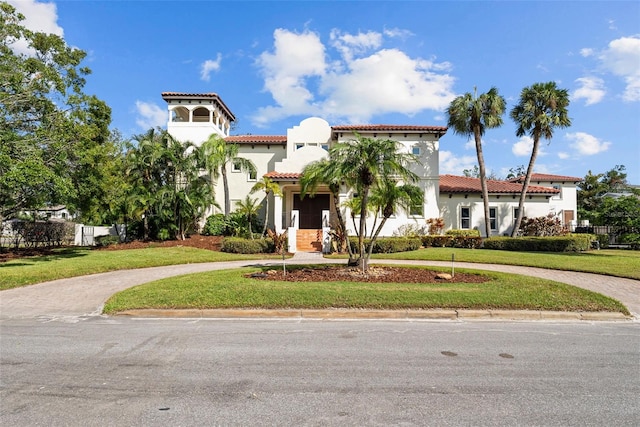 mediterranean / spanish home featuring a front yard