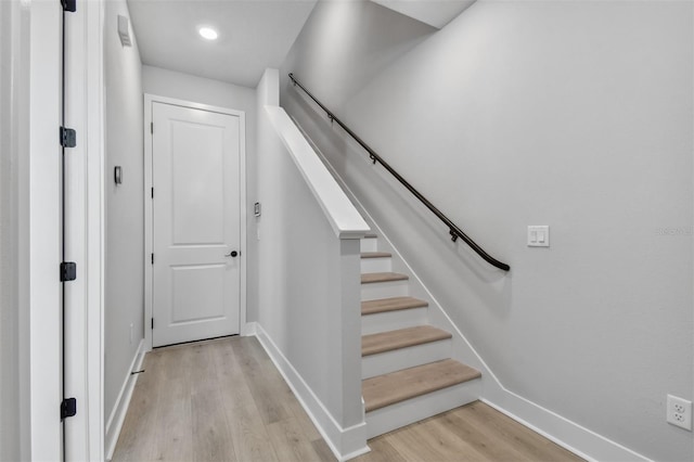 staircase with hardwood / wood-style flooring