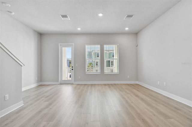 interior space featuring a textured ceiling and light wood-type flooring