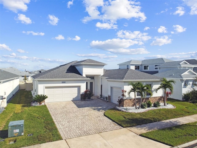 view of front of home featuring a front yard and a garage