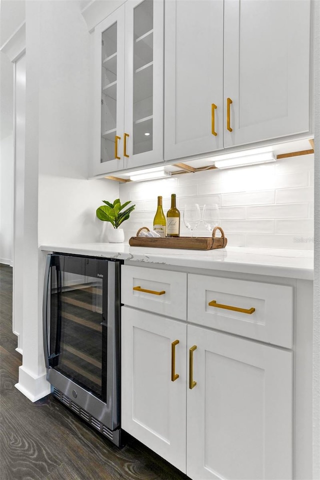 bar with beverage cooler, white cabinetry, dark hardwood / wood-style flooring, and tasteful backsplash