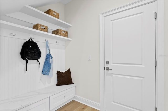 mudroom featuring lofted ceiling and light wood-type flooring