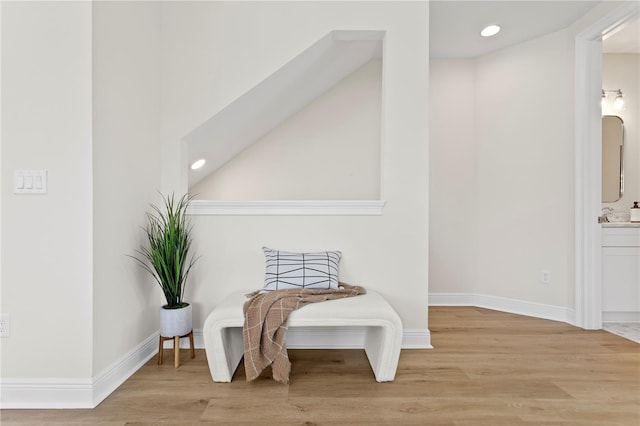 sitting room featuring sink and light hardwood / wood-style flooring