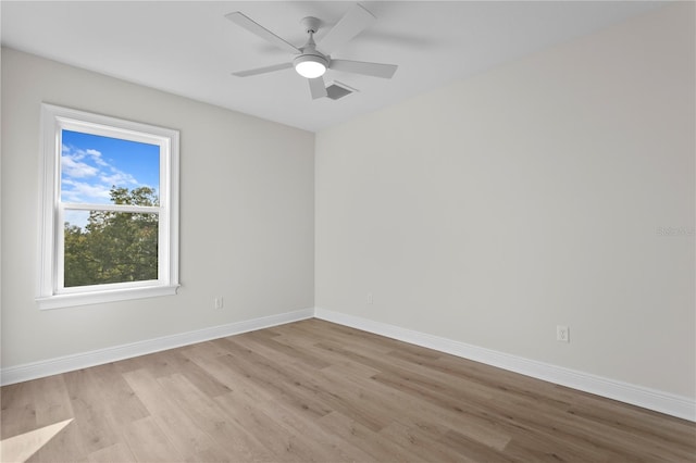 empty room with light hardwood / wood-style flooring and ceiling fan