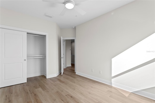 unfurnished bedroom featuring ceiling fan, a closet, and light hardwood / wood-style floors