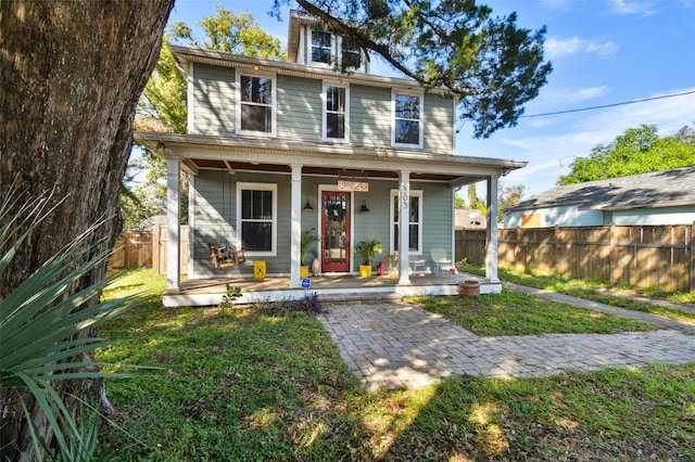 view of front facade with a front lawn and covered porch