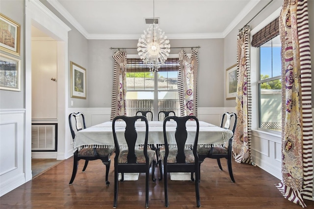 dining space with dark wood-type flooring, a healthy amount of sunlight, and ornamental molding