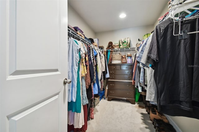 walk in closet with carpet flooring