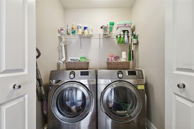 clothes washing area with separate washer and dryer