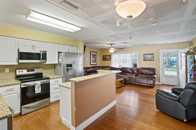 kitchen with appliances with stainless steel finishes, white cabinetry, light wood-type flooring, and ceiling fan