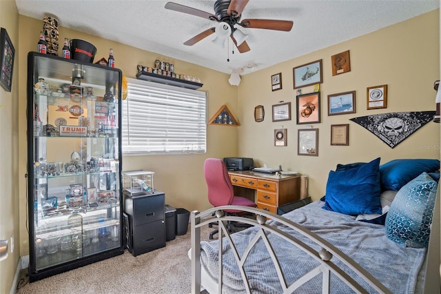 bedroom featuring light carpet, a textured ceiling, and ceiling fan