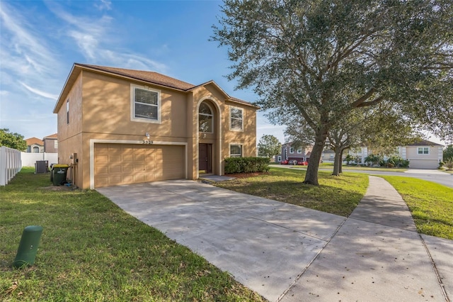 front of property featuring a front lawn and a garage