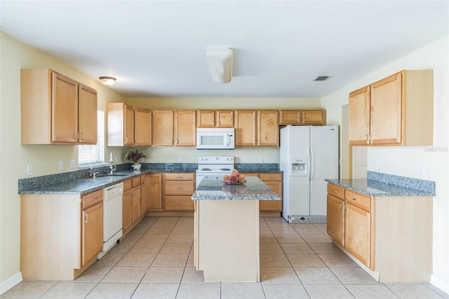 kitchen with white appliances, light tile patterned floors, a center island, and sink