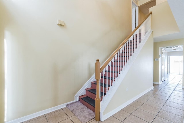 staircase featuring tile patterned flooring